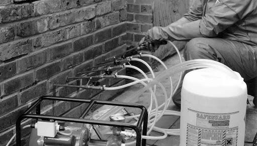 Chemical DPC injection being carried out on a brick wall