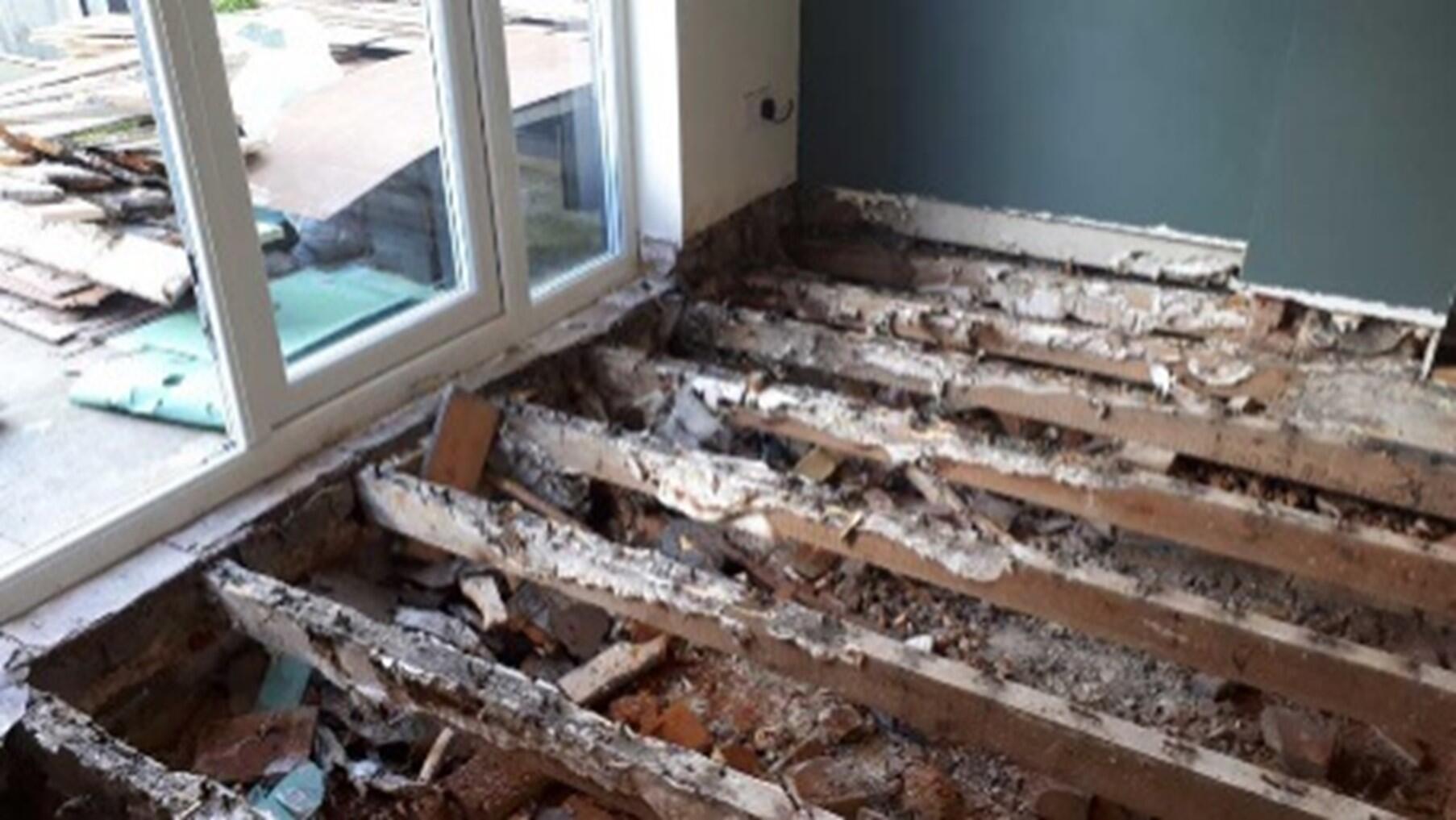 Floor joists destroyed by dry rot requiring full replacement