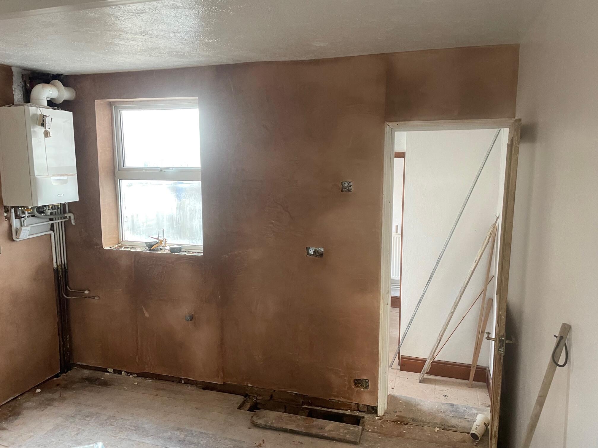 Professional plasterer skimming a wall