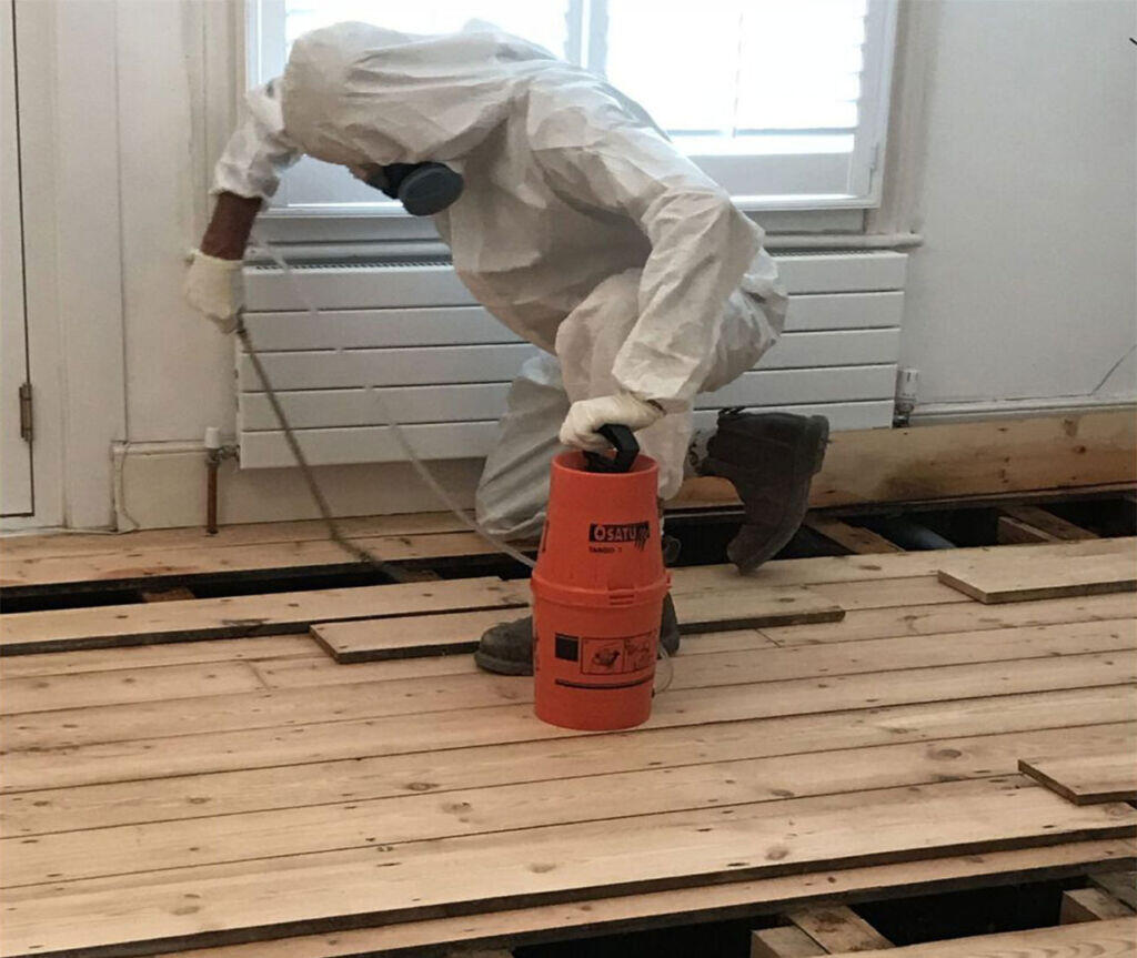 Technician spraying timber